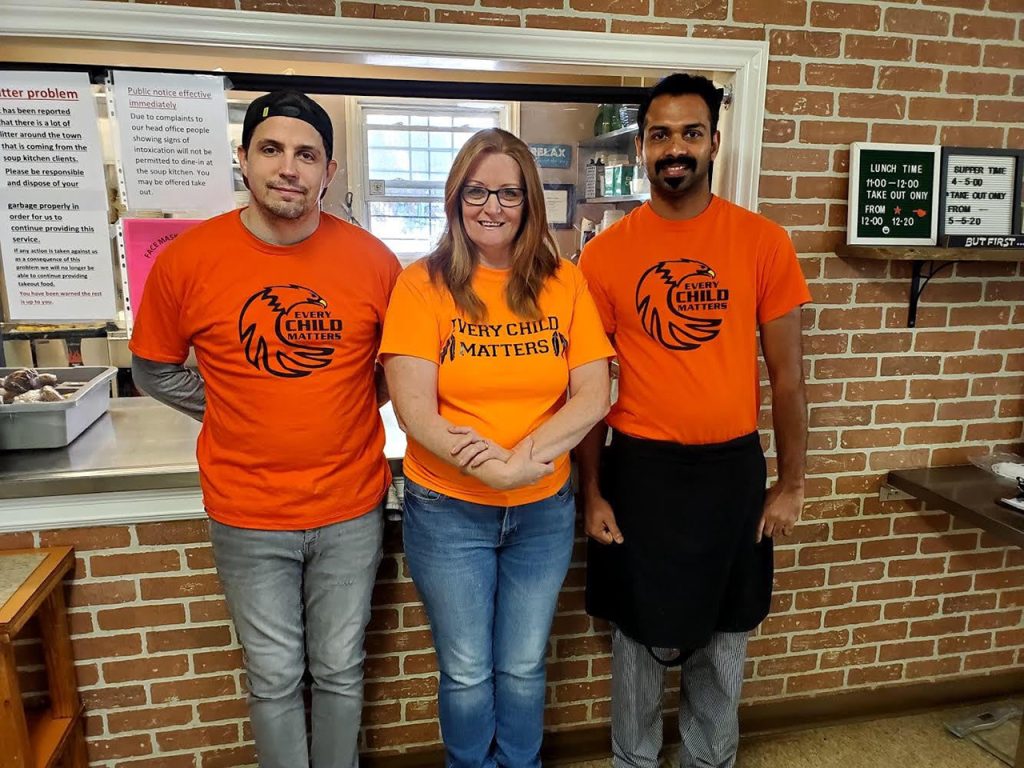 Soup Kitchen, 3 staff members in orange 'Every Child Matters' t-shirts.